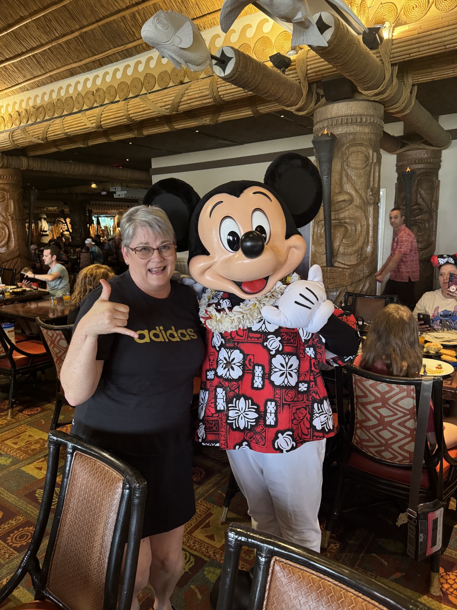Solstice Travel advisor enjoying a character dining experience with Mickey Mouse