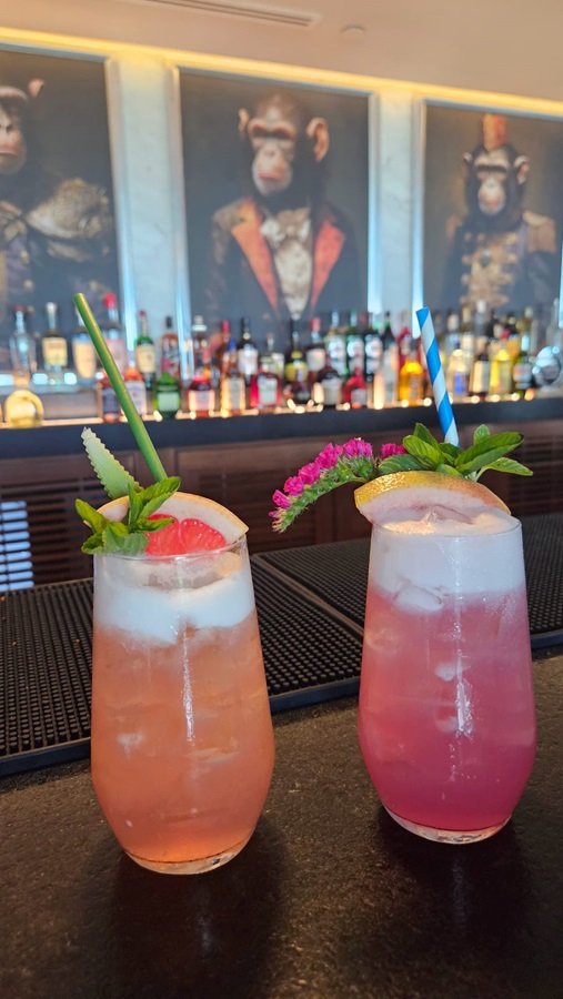 Two colorful tropical cocktails at a resort bar
