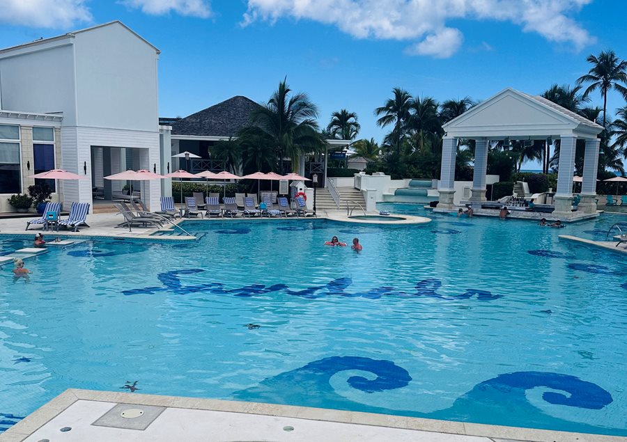 Turquoise pool and white buildings at an all-inclusive resort